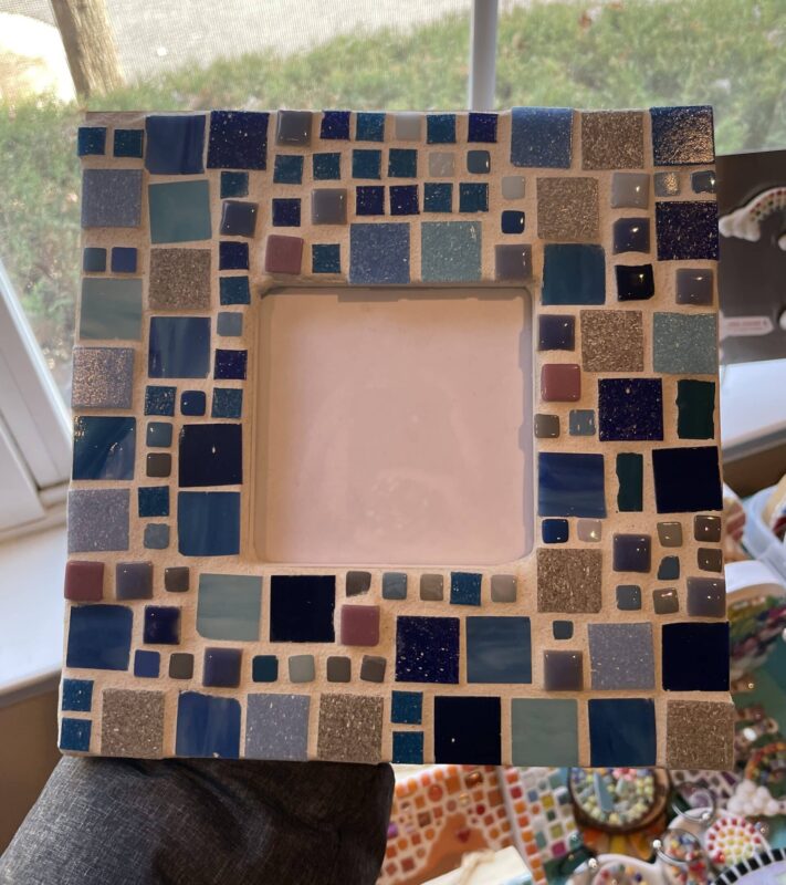 a picture frame decorated with a mosaic