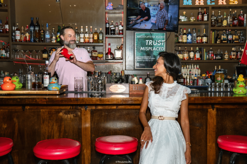 josh mixes a drink while a customer looks on