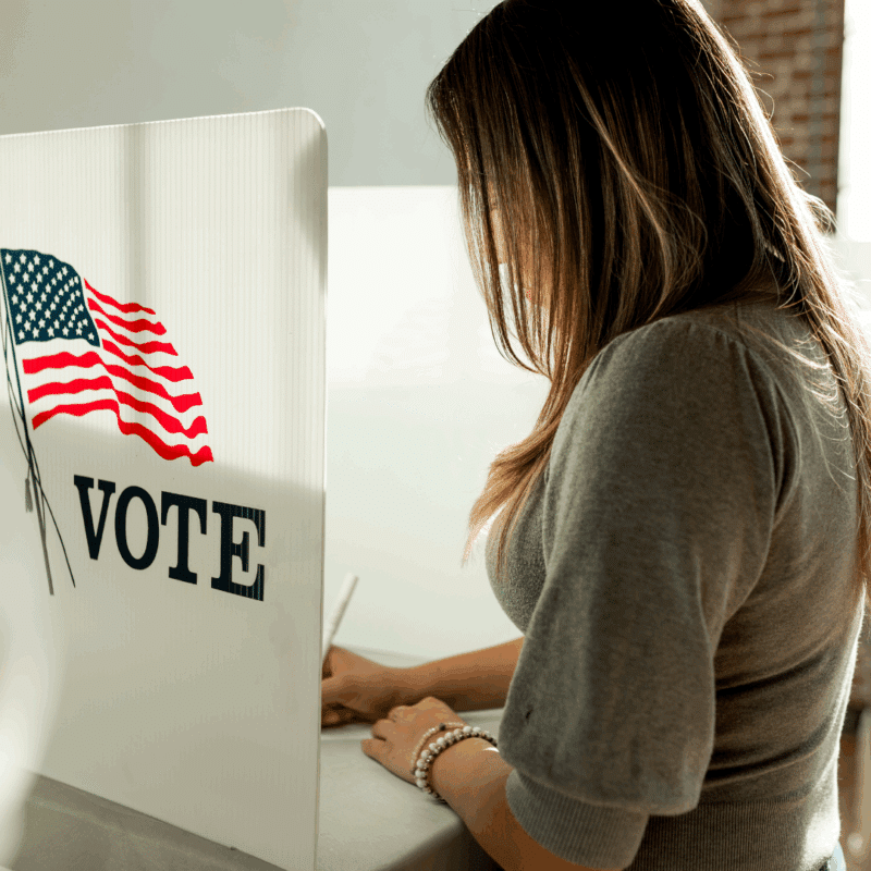 a woman casts her ballot