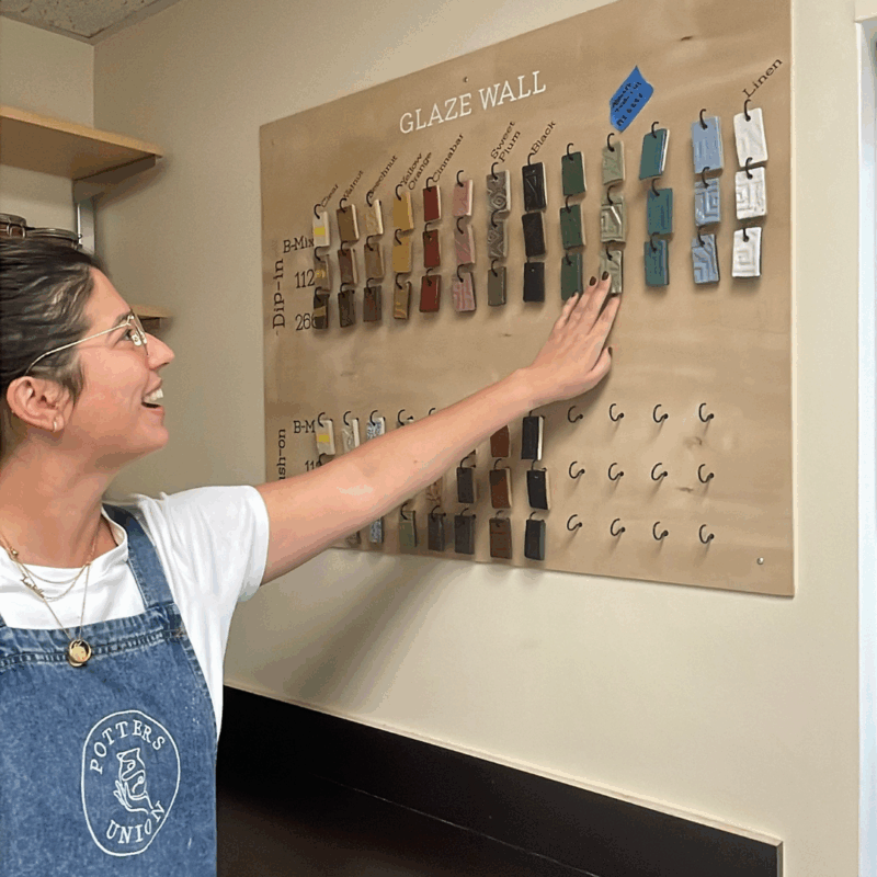 paola shows off the glazes at potters union