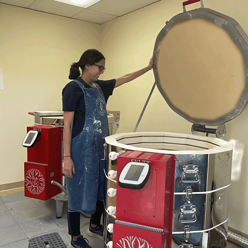 jennie shows off the kilns at potters union 