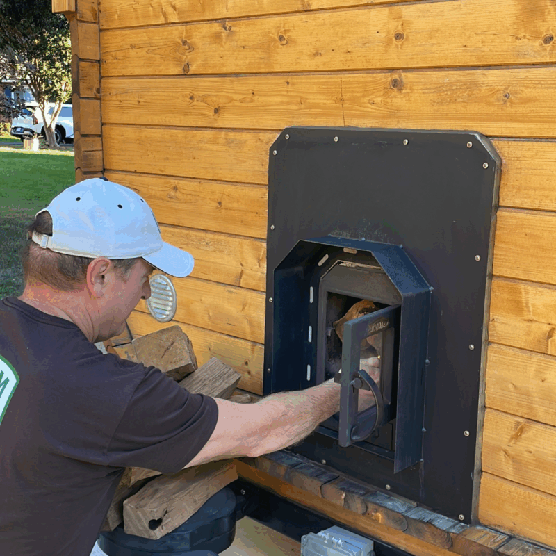 feeding the fire at the steam + chill sauna