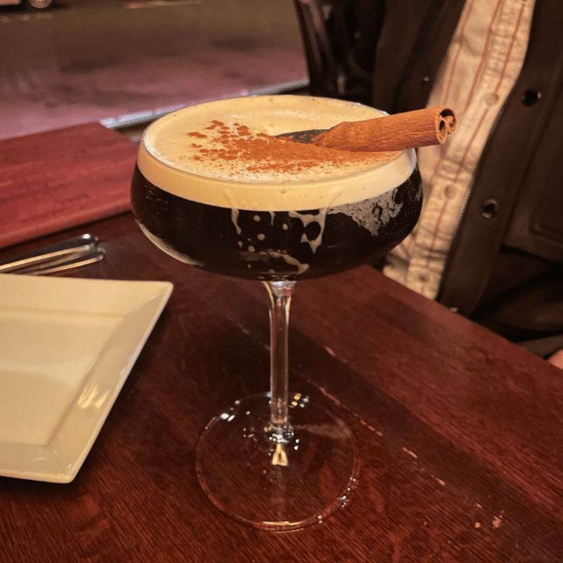 Espresso martini with cinnamon stick garnish