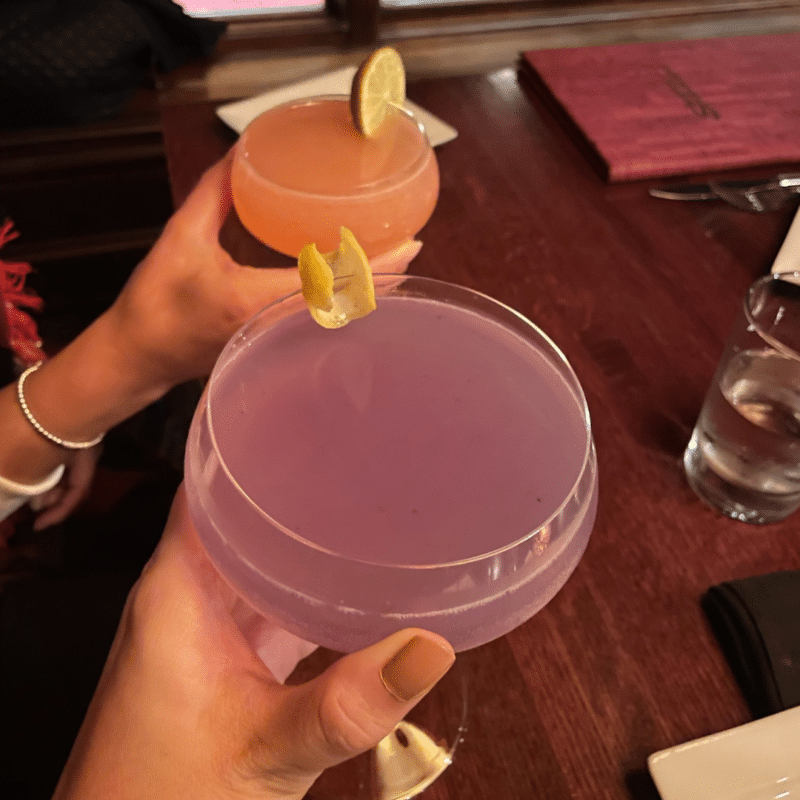 Two hands holding cocktails